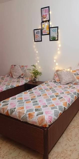 Elegant pink bedroom at Sai Kriti Girls PG in Aliganj Lucknow